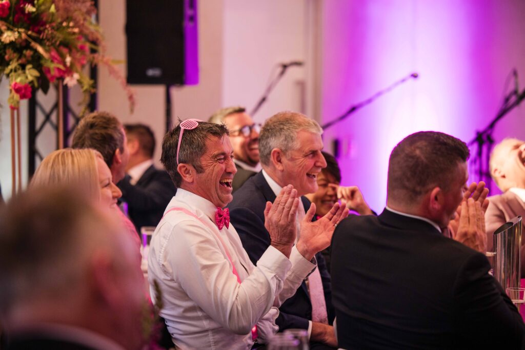Guests laughing at magic show