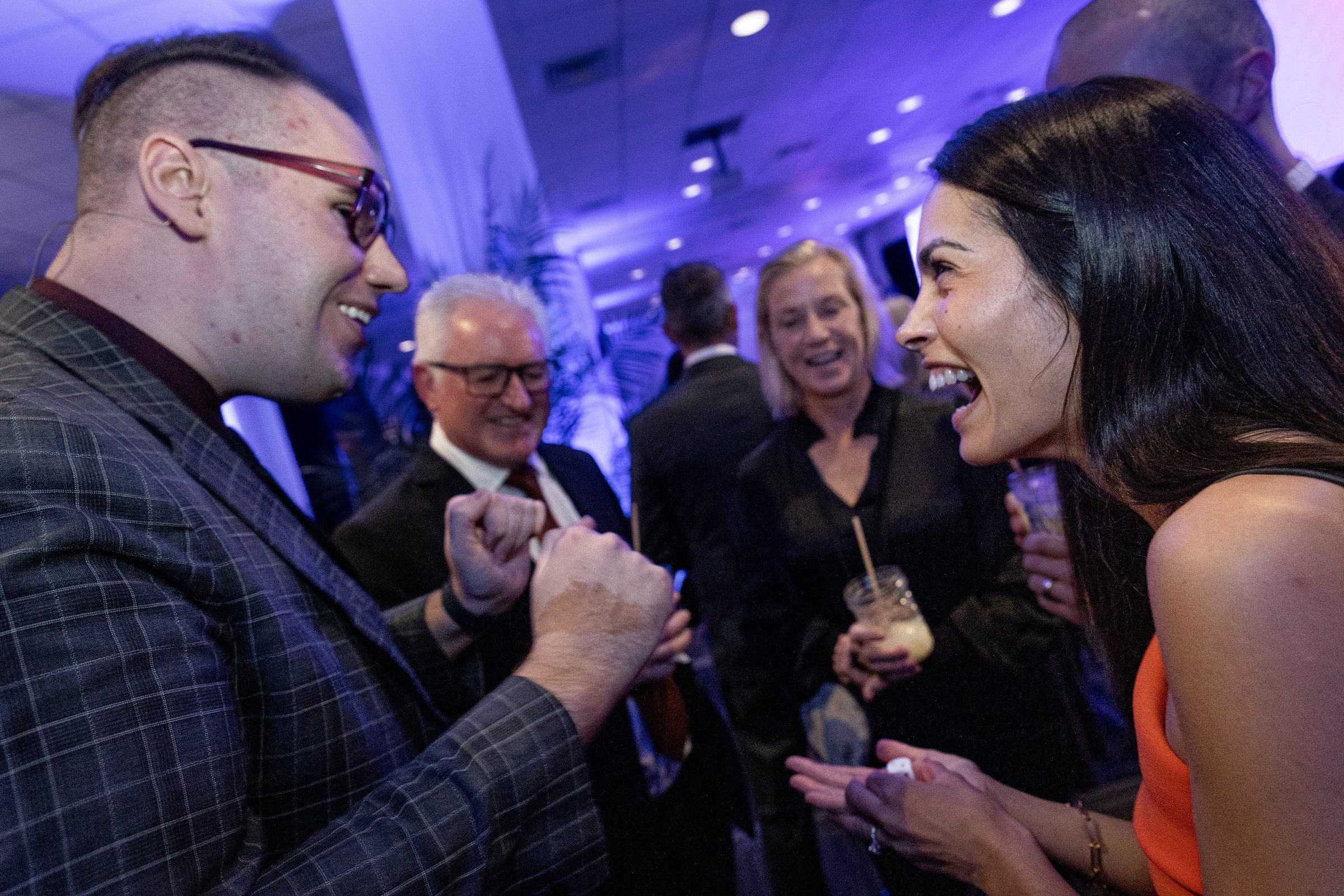 Guests reacting to cocktail magic during arrival drinks at an awards night in Auckland, New Zealand
