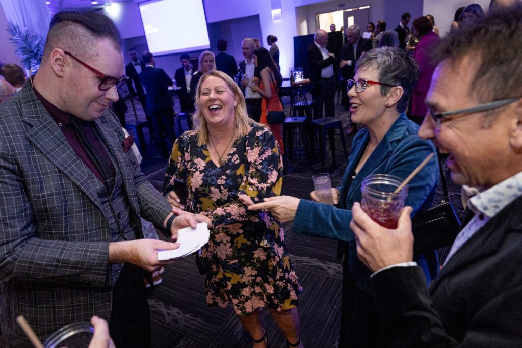 Corporate magician Brendan Dooley performing cocktail magic for guests at an Auckland event