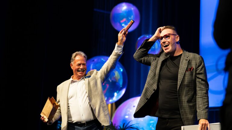 Brendan Dooley Comedy Magician and MC on stage at a corporate event in Auckland