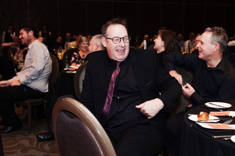 Guests laughing during entertainment at an end of year function