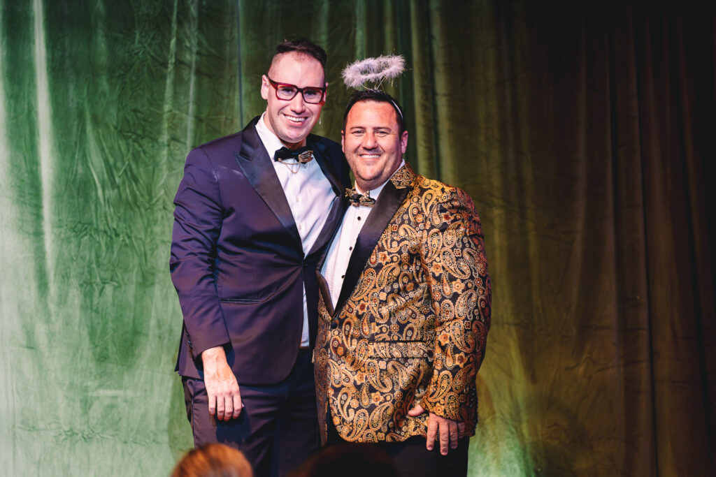 Brendan Dooley on stage with a guest at the Stonewood Homes Enchanted Forest gala