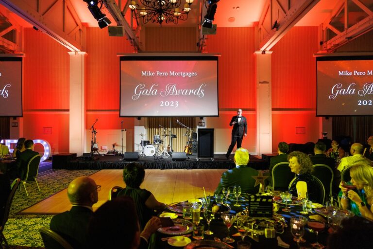 Corporate awards night in New Zealand, comedy magician and MC Brendan Dooley on stage at a gala dinner
