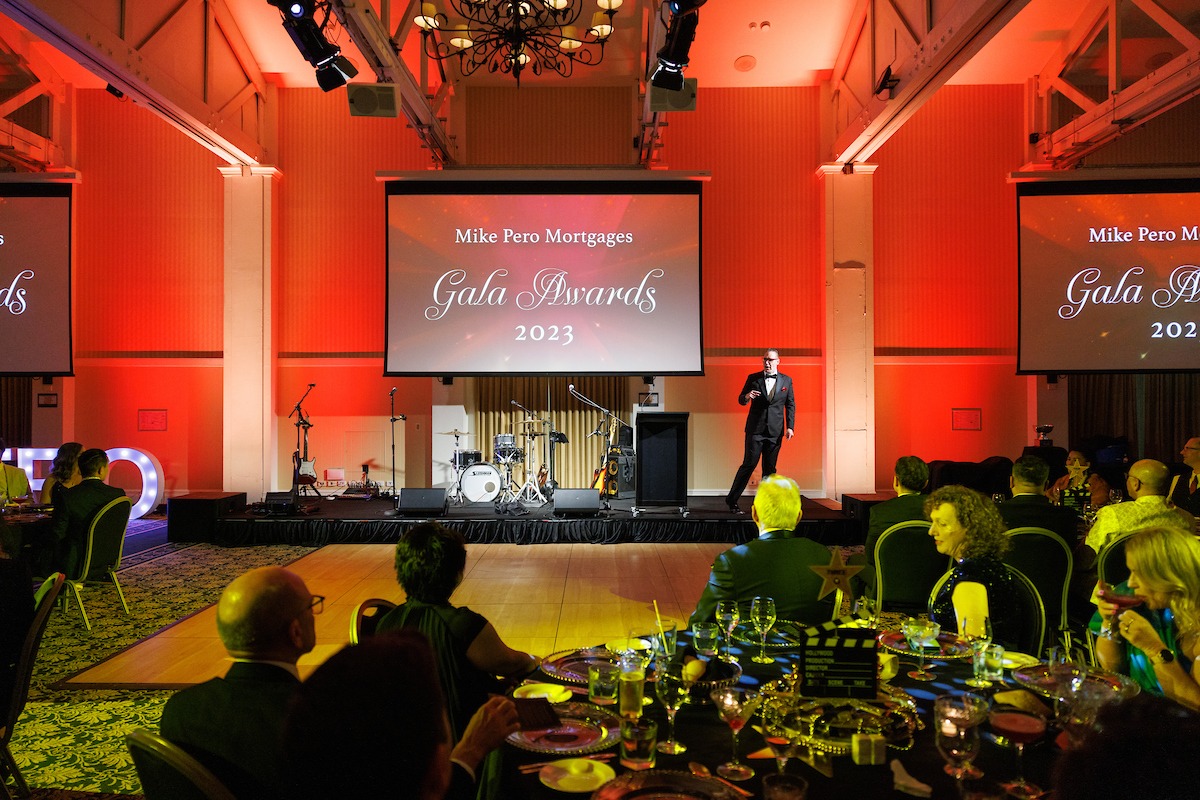 Corporate awards night in New Zealand, comedy magician and MC Brendan Dooley on stage at a gala dinner