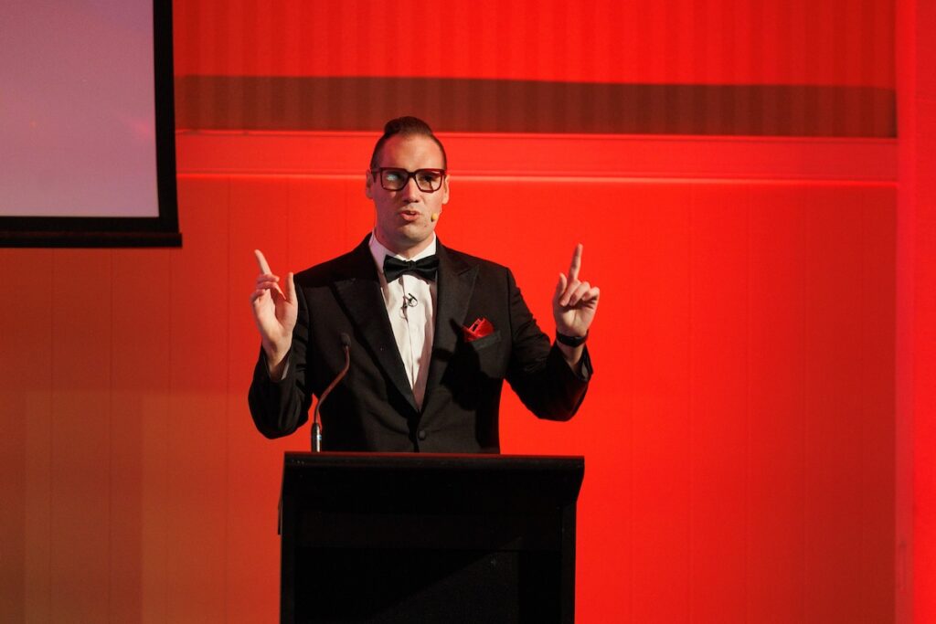Brendan Dooley hosting a black tie corporate awards night as MC
